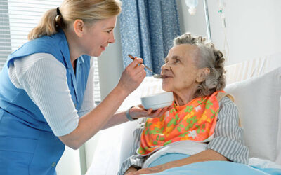 senior woman 90 years old being fed by a nurse